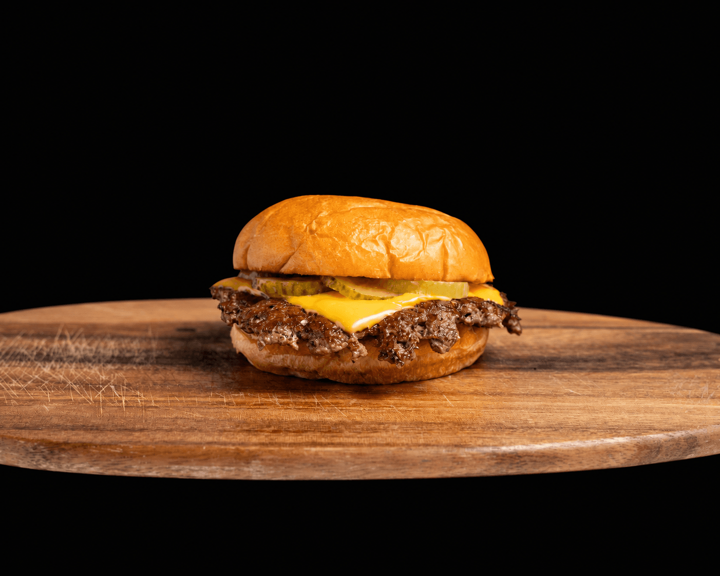 Proper Burger single smashburger with cheese and pickles.